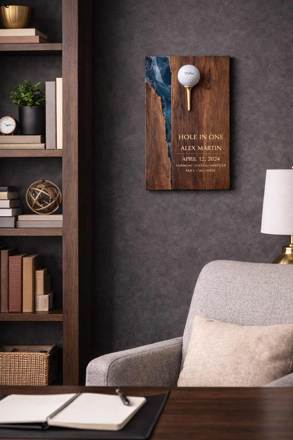 Walnut hole-in-one plaque with blue epoxy resin detail, golf ball on gold tee, mounted in a study setting.